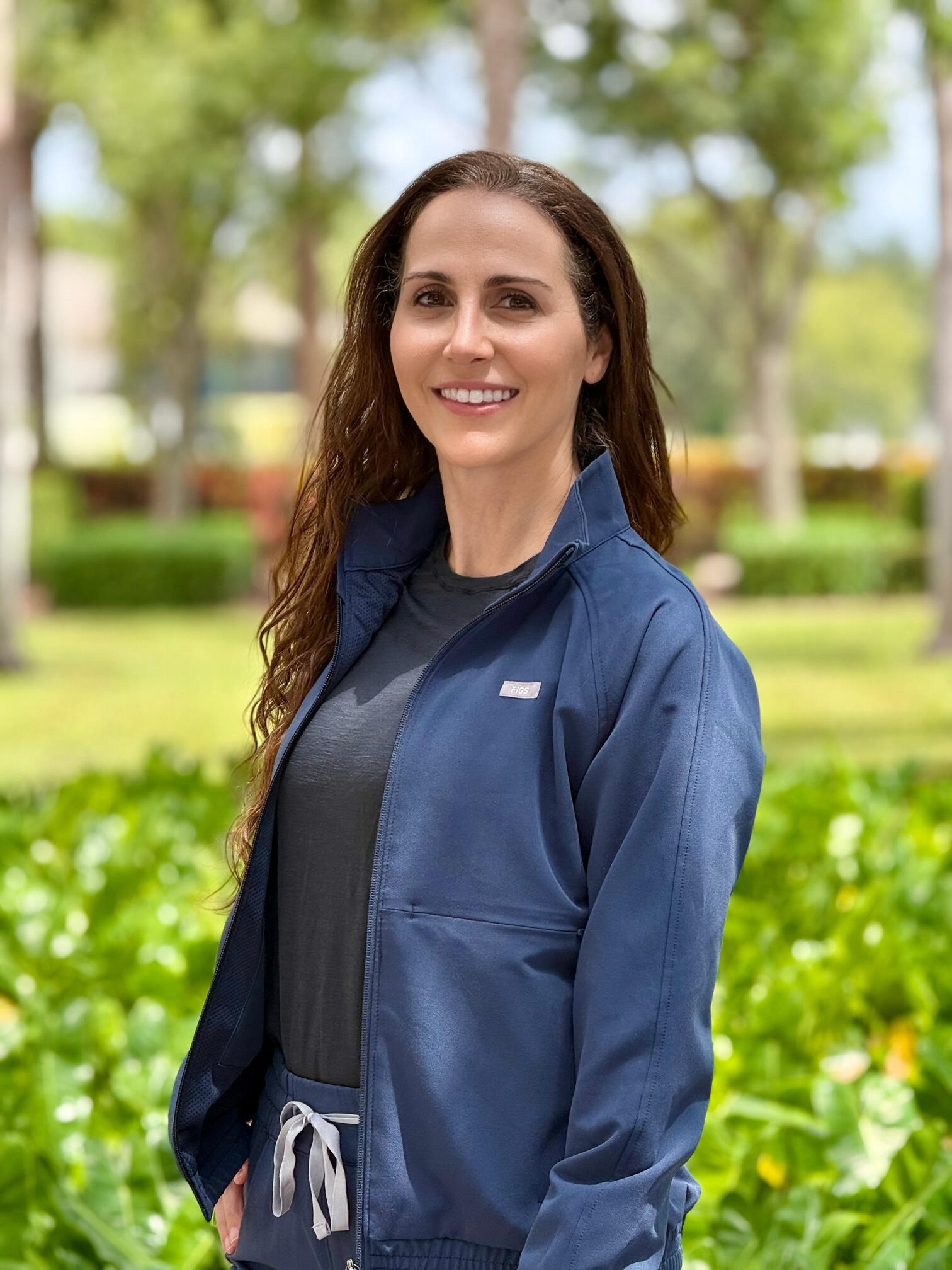 Headshot of myofunctional therapist Nancy Groeniger smiling warmly against a blurred outdoor background